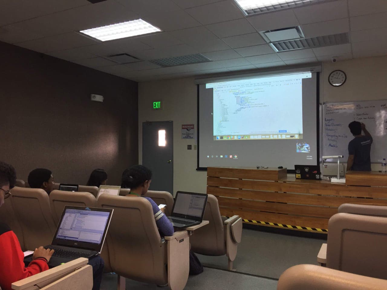 Sarang teaching an Android development workshop at a whiteboard